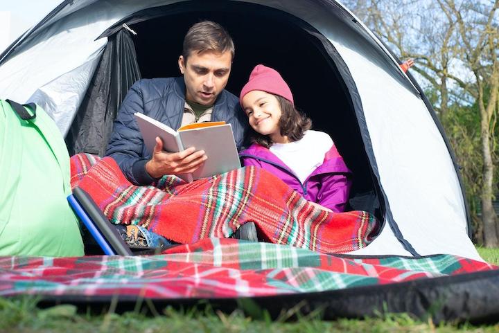 A father and his daughter camping.